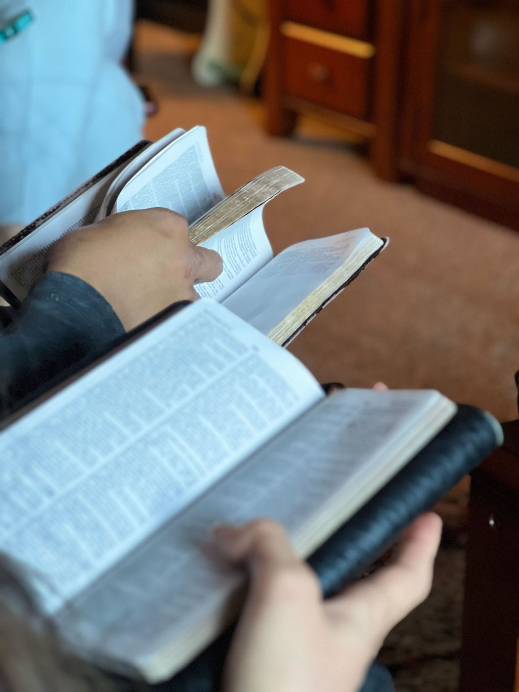 Open King James Bibles held during a Bible study at Summit Bible Baptist Church